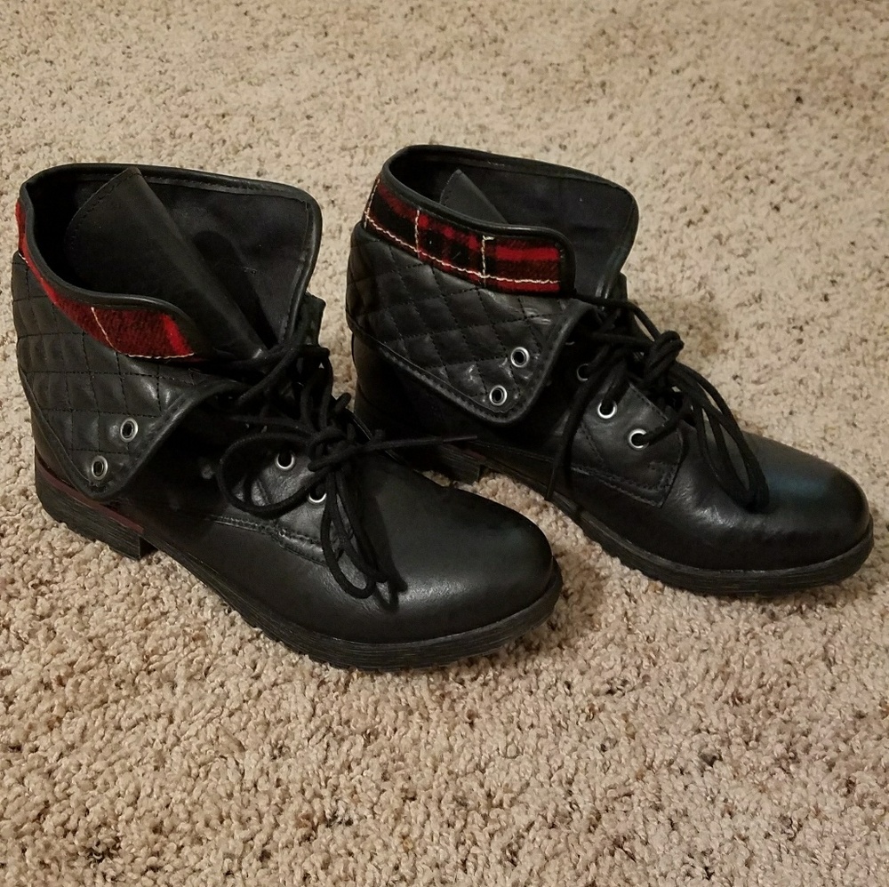 Black combat boots with red plaid detail